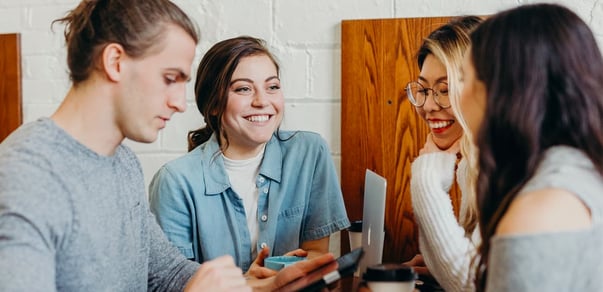 Four people having a conversations at the office